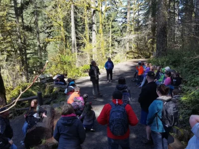 Guided group hike through the forest trails of Silver Falls State Park, with families and children gathered for an outdoor educational program
