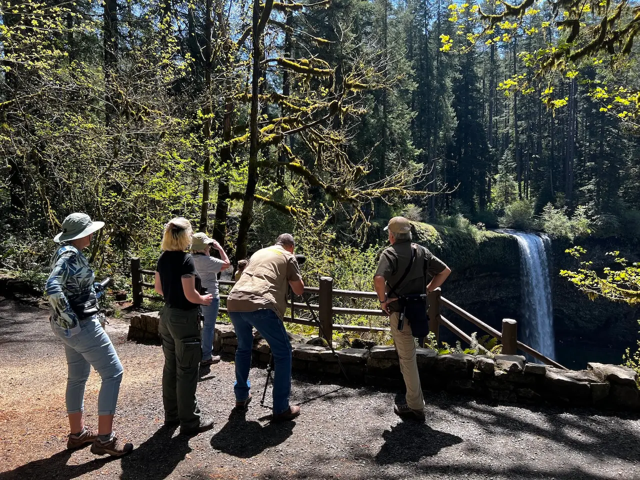 Visitors enjoying an interpretive nature program while overlooking South Falls