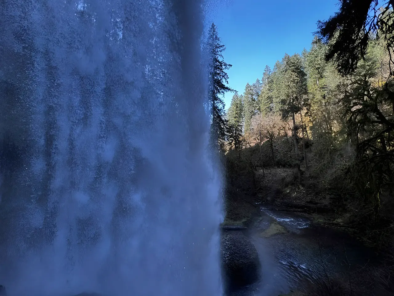 Behind South Falls waterfall along scenic canyon trail